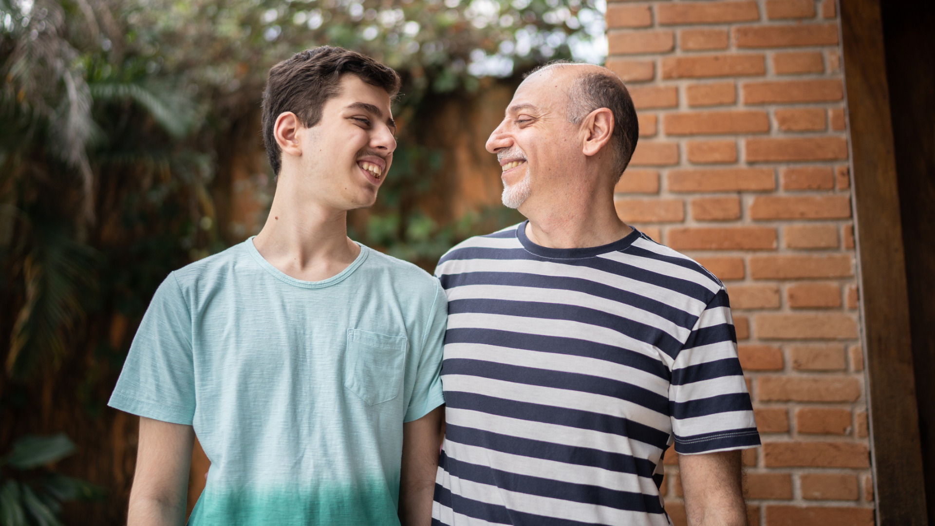 Father and son looking at each other at home