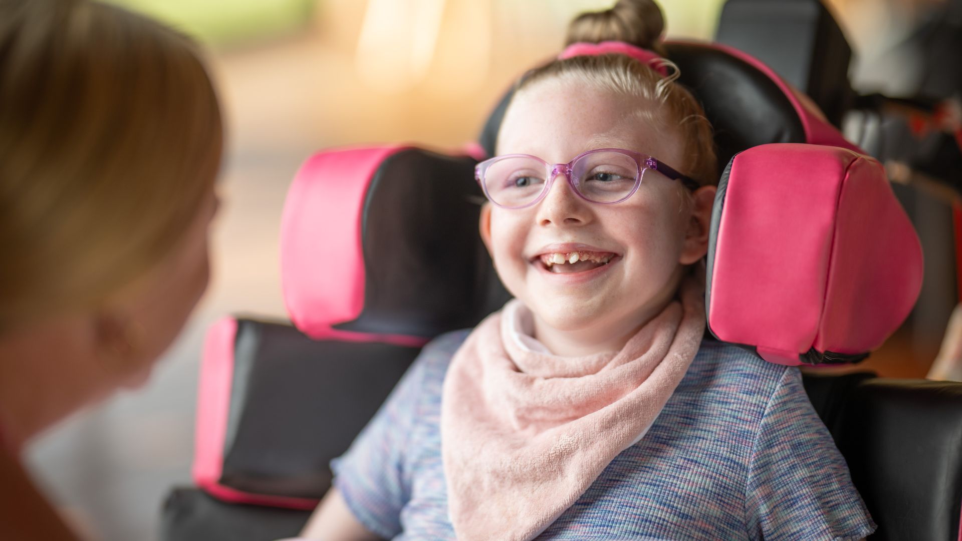 Close up of MyIntegra Support Coordination client, Emily, smiling in her wheelchair