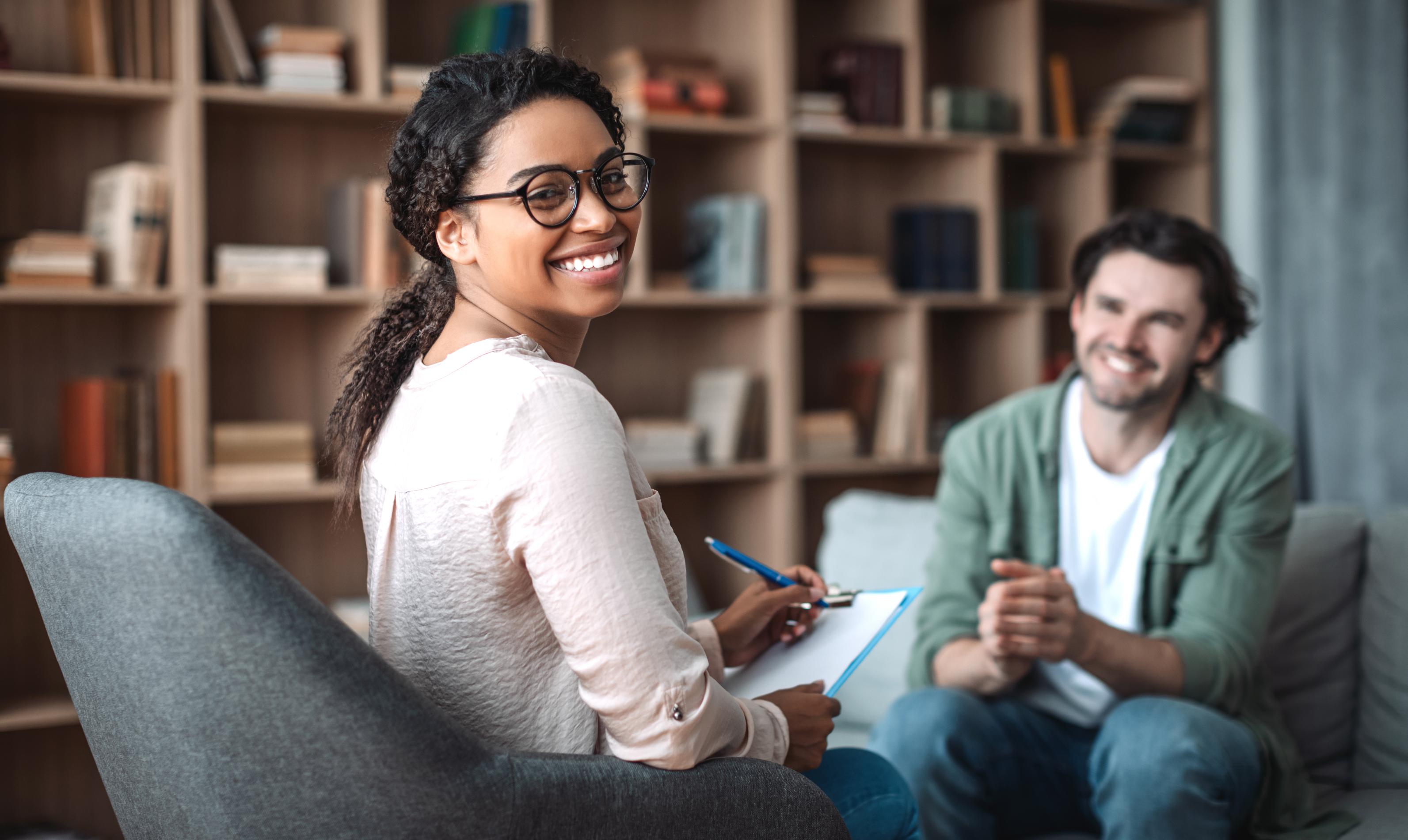 A smiling professional holding a clipboard, representing a MyIntegra plan manager taking over financial admin for a client