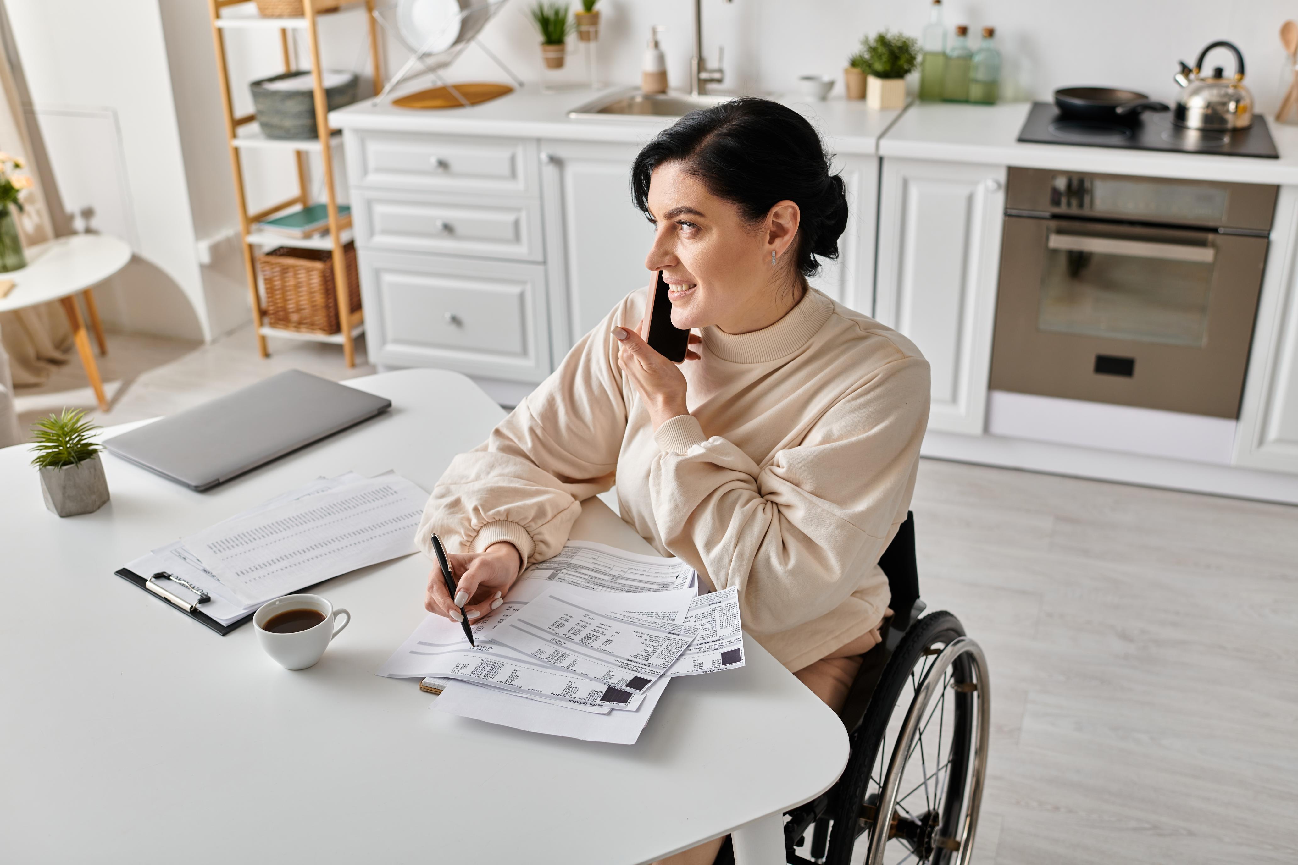 NDIS participant reviewing NDIS plan documents with a plan manager during a phone call