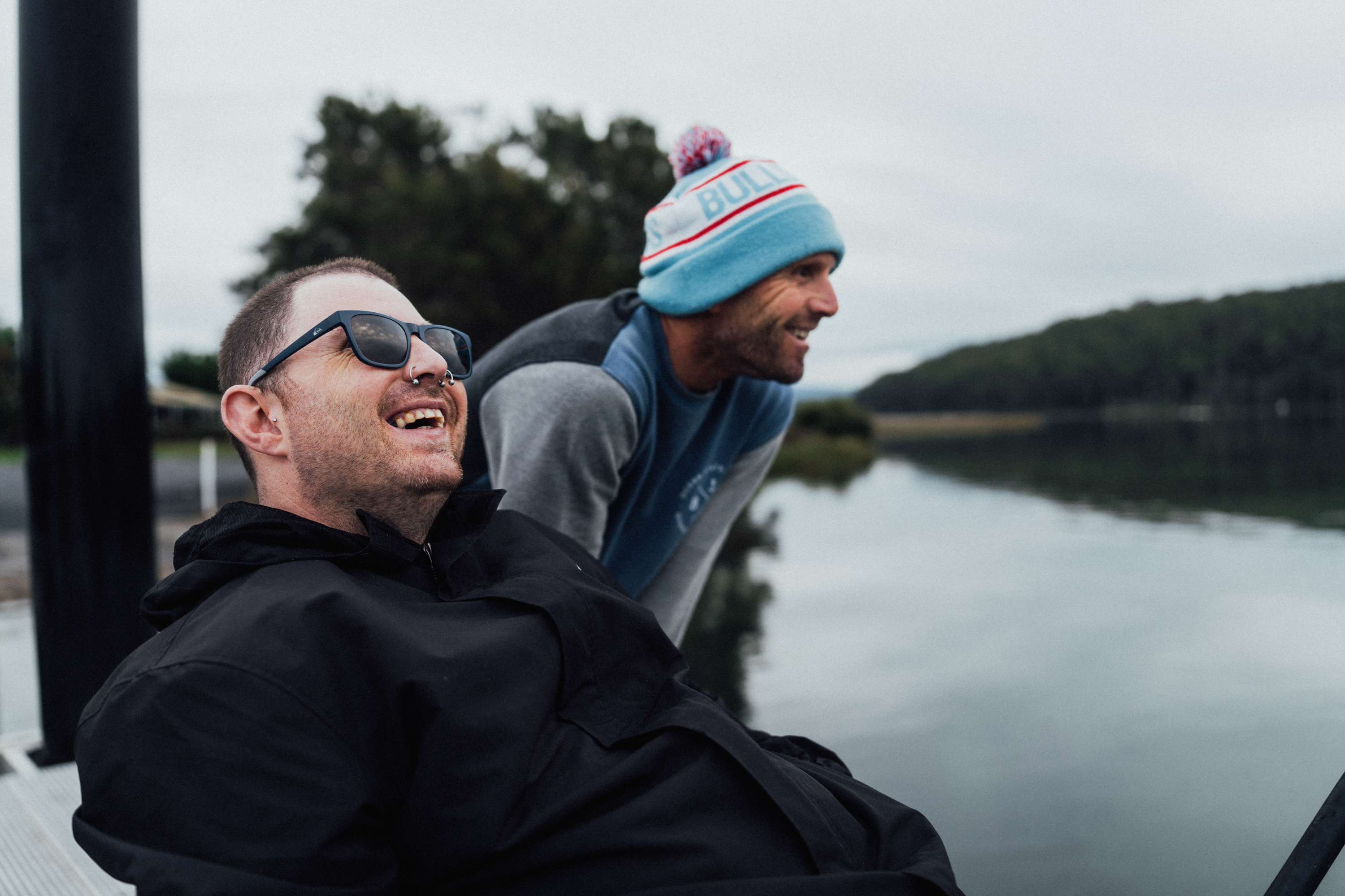 Harley fishing and smiling with support worker.